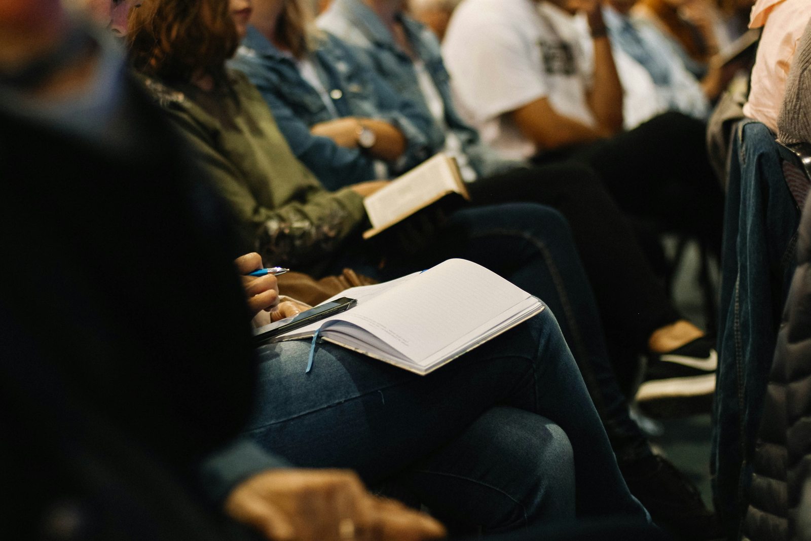 People taking notes during a Bible study or teaching time